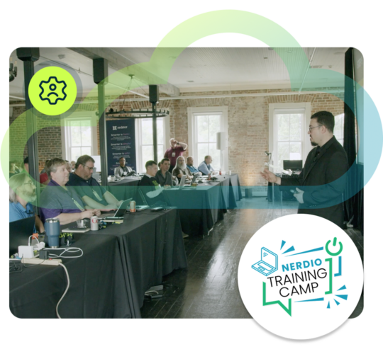 man presenting to room of people sitting at tables, blue and green cloud outline, white circle with training camp logo, green circle with gear icon