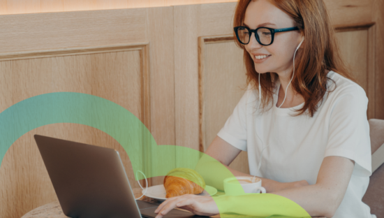 girl with glasses at a cafe on her laptop