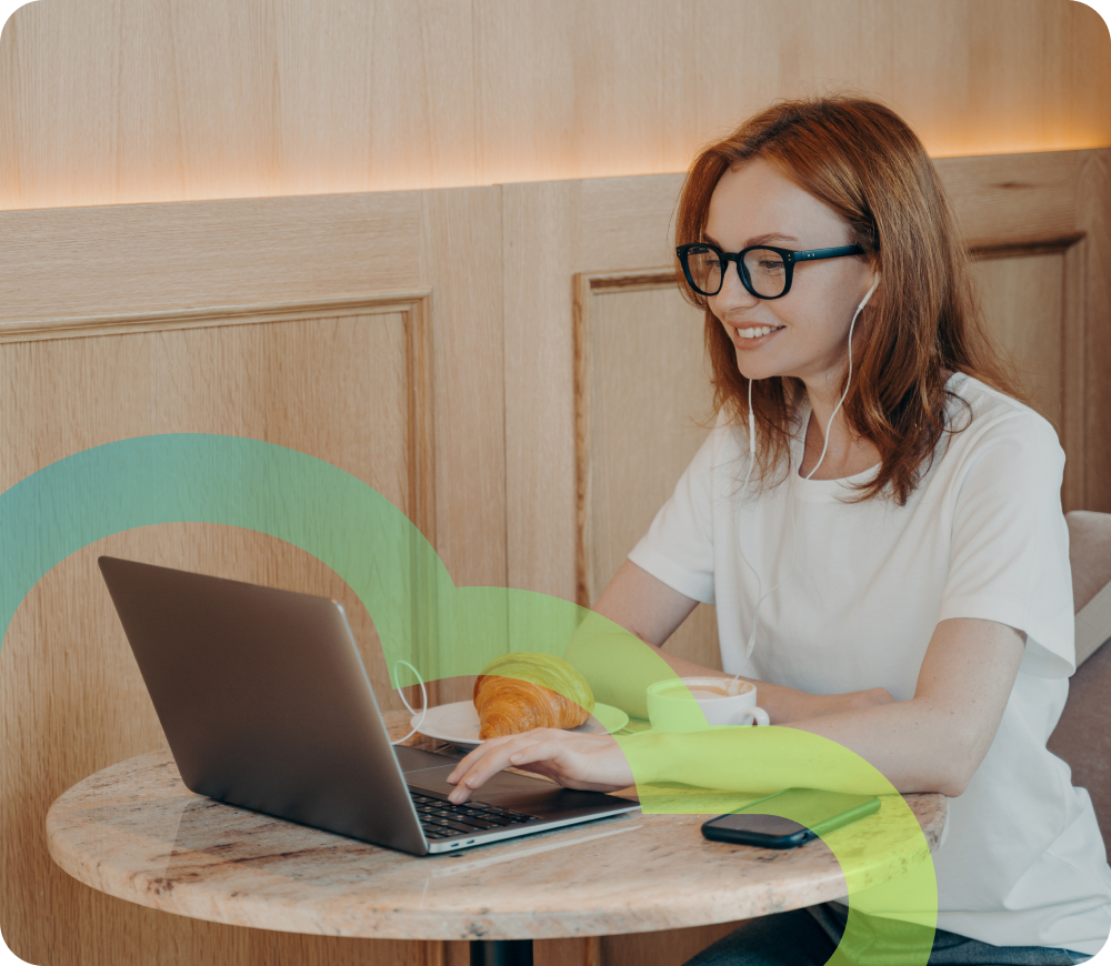 girl with glasses at a cafe on her laptop