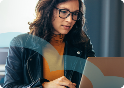 woman with glasses working on laptop