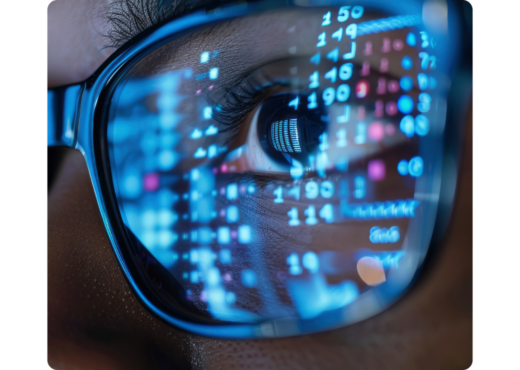 Closeup of glasses reflecting data on a screen